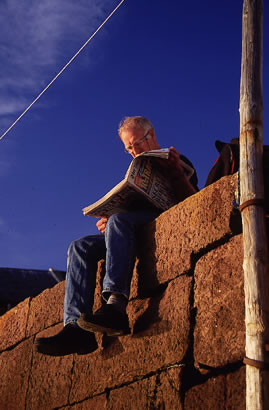 Man reading paper on wall in North Berwick