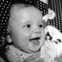 Black and white photo of a grinning baby